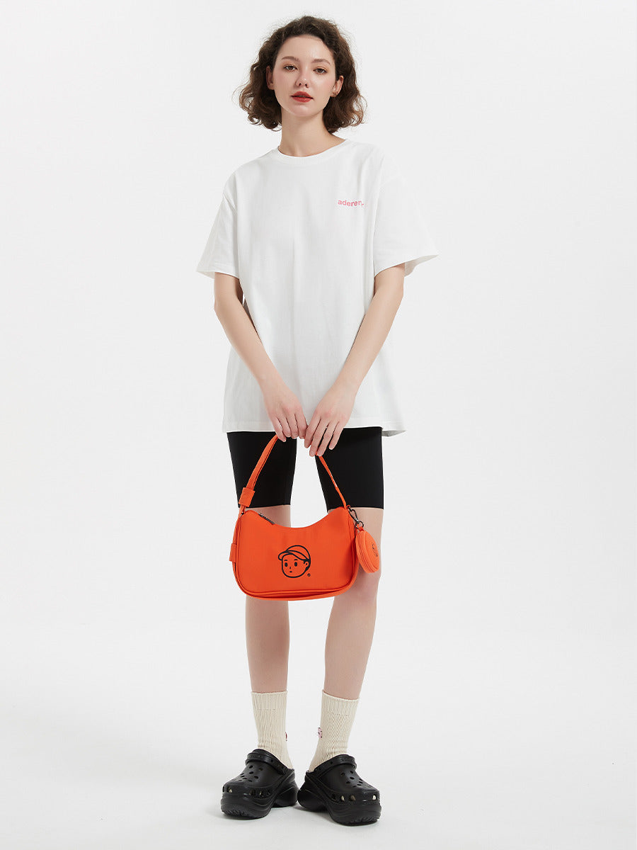Nylon Shoulder Bag in Soft Orange – on-body shot 02