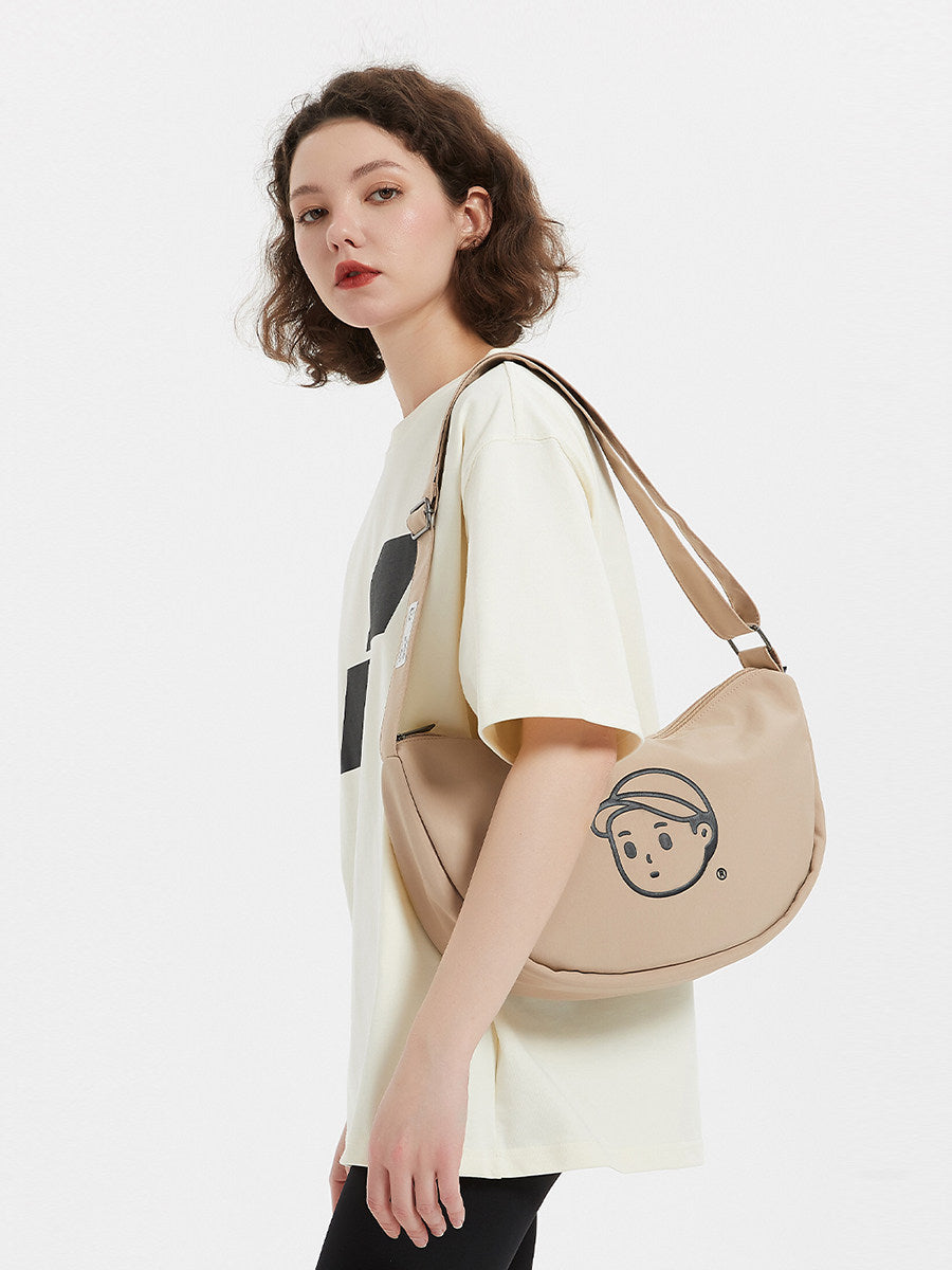 FINERWORLD Crescent Dumpling Crossbody Bag in Rock Sand - on-body shot